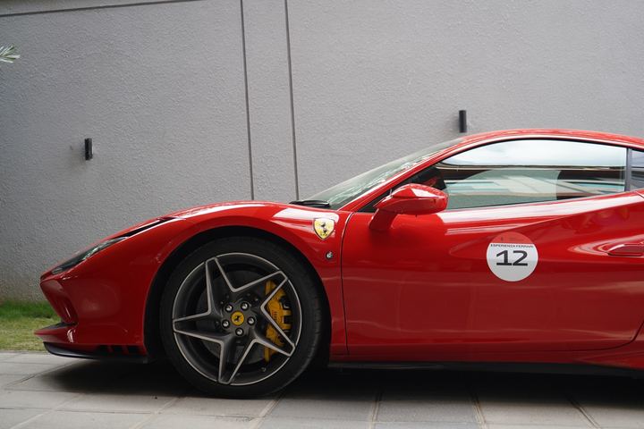 Front three-quarter view of a red Ferrari with number 12.