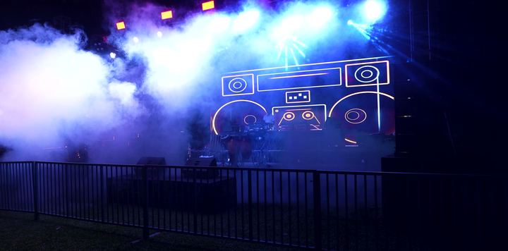 Blue haze rolls over the boombox stage.