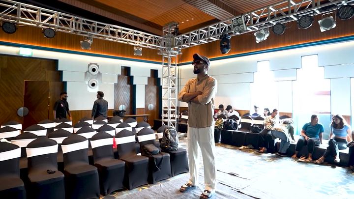 Choreographer watches rehearsals in the ballroom before the finale.