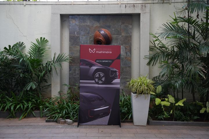 Mahindra standee and a stone wall planter at the event entrance.