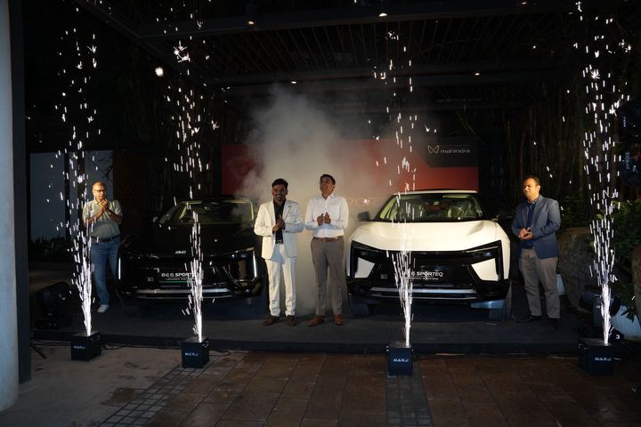 Smoke and sparks around the revealed BE 6 and its presenters.