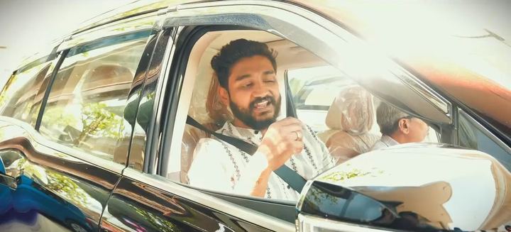 New owner smiles behind the wheel of his SUV.