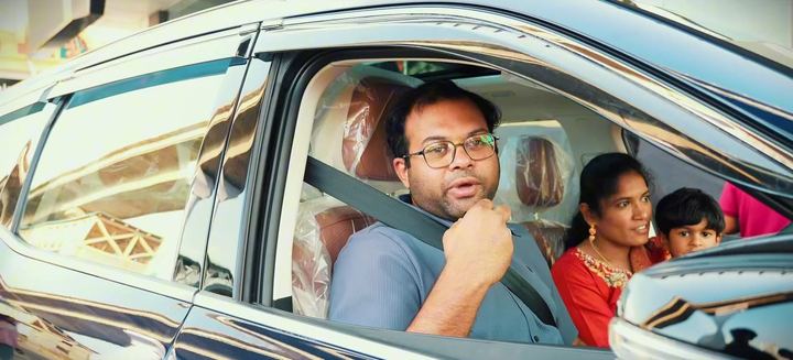 Family sits inside their new SUV for the first drive.