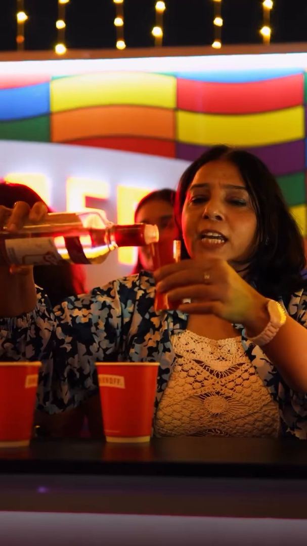 A guest pours a drink at the Smirnoff bar.